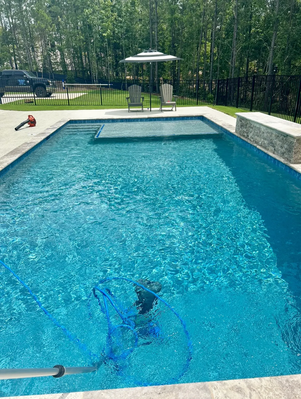 Pool vacuuming in progress during a routine service visit